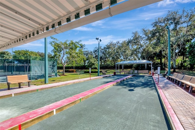 view of property's community featuring fence