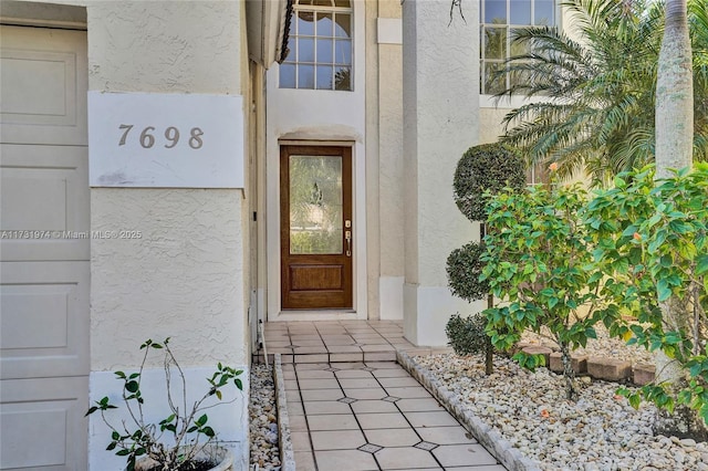 property entrance featuring stucco siding