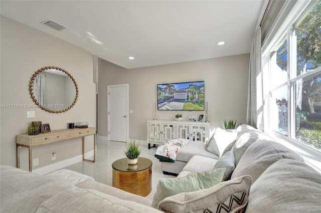 living area featuring recessed lighting, visible vents, and baseboards