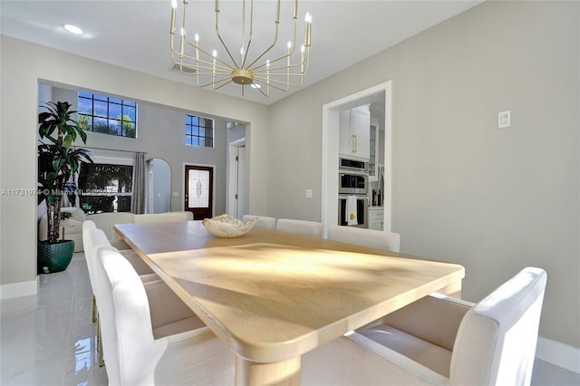 dining space with recessed lighting, baseboards, and a chandelier