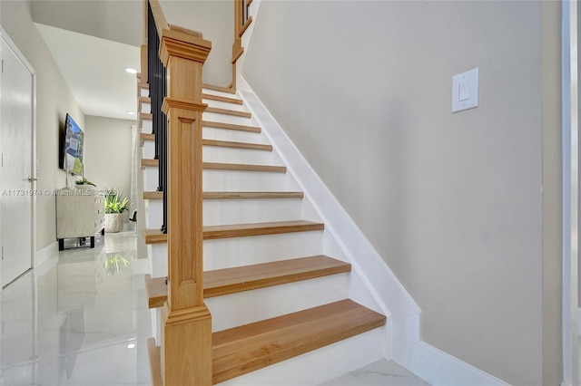 staircase featuring recessed lighting and marble finish floor