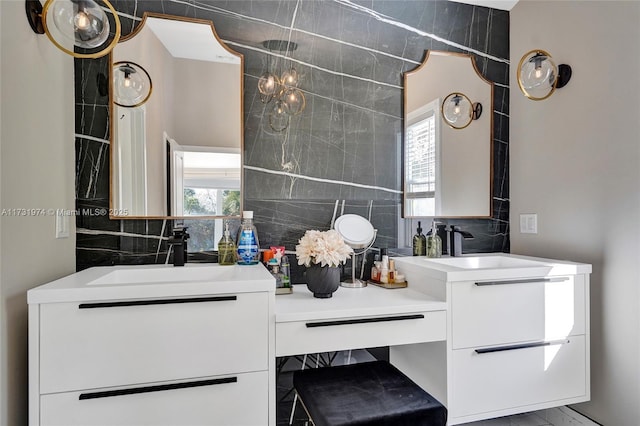 bathroom featuring plenty of natural light, backsplash, and vanity