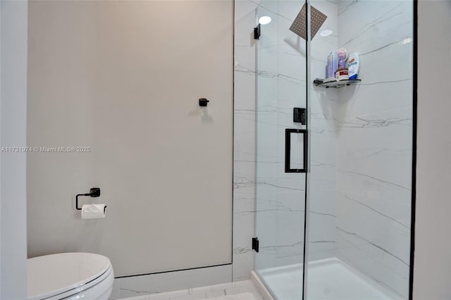 bathroom with a marble finish shower and toilet