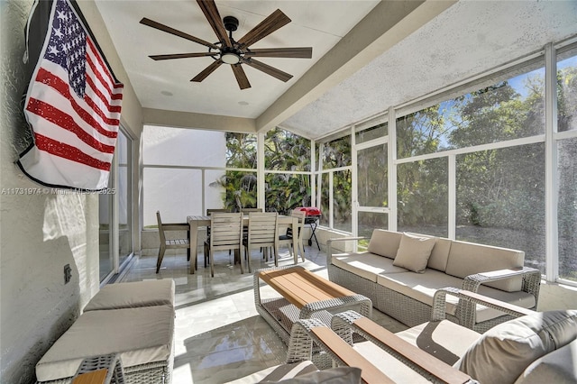 sunroom / solarium featuring a ceiling fan