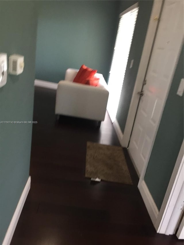 hall featuring baseboards