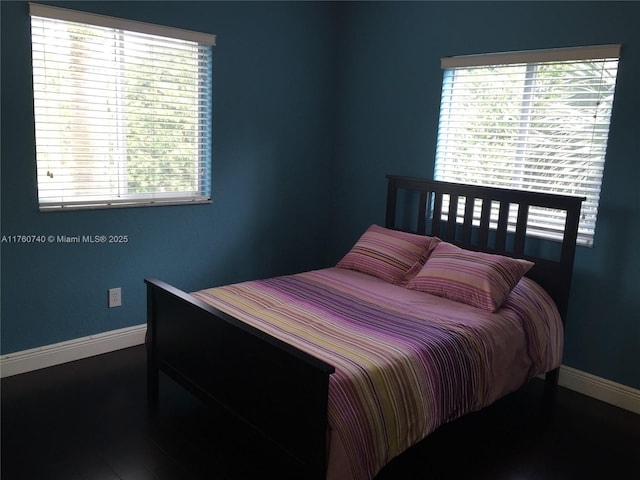 bedroom featuring baseboards and wood finished floors