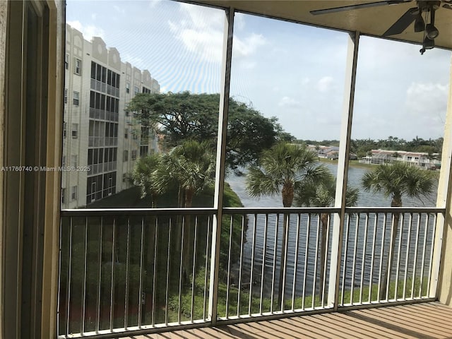 exterior space featuring a water view and ceiling fan