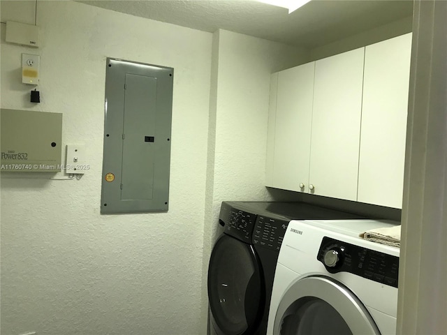 laundry room featuring electric panel, cabinet space, independent washer and dryer, and a textured wall