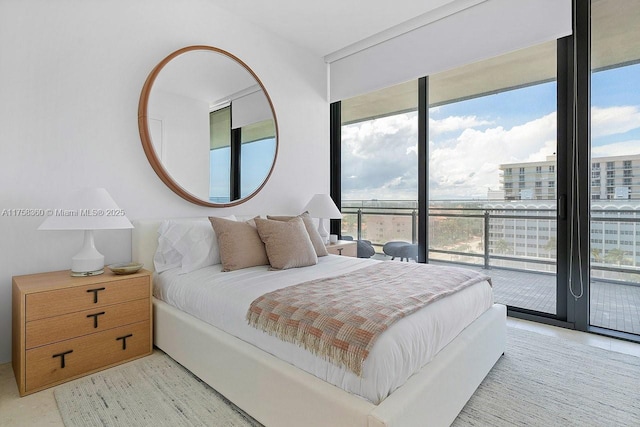 bedroom featuring a wall of windows and access to outside