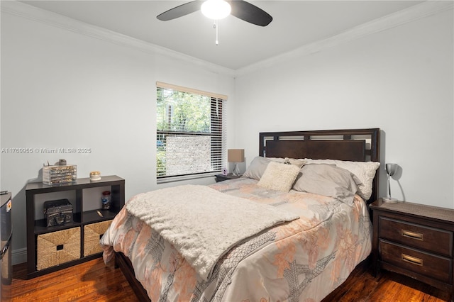 bedroom with a ceiling fan, ornamental molding, and dark wood-style flooring