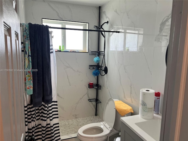 full bath featuring vanity, toilet, and a marble finish shower