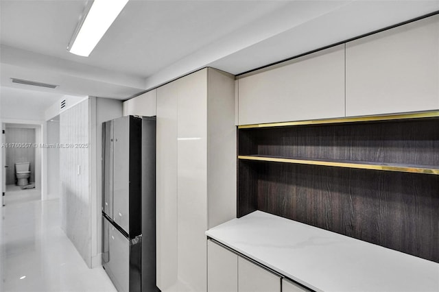 kitchen with visible vents, white cabinets, and modern cabinets