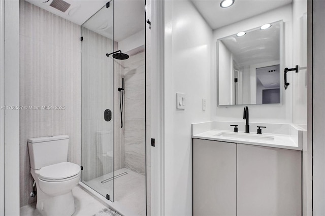 bathroom with visible vents, toilet, a stall shower, and vanity