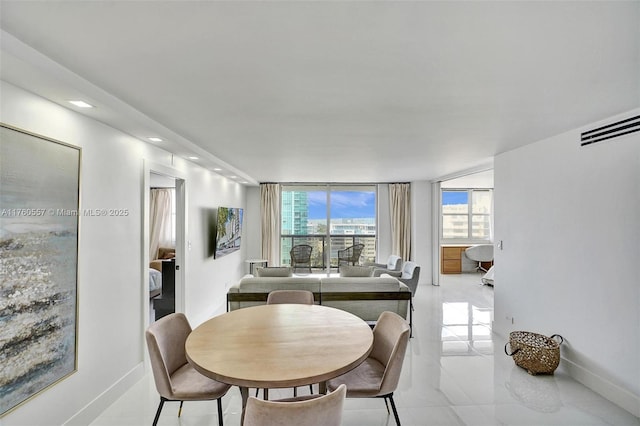 dining space featuring recessed lighting, baseboards, and expansive windows