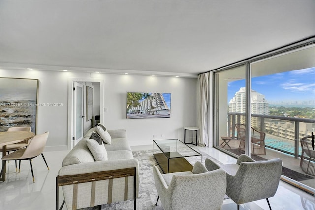 living area featuring a city view, floor to ceiling windows, recessed lighting, and baseboards