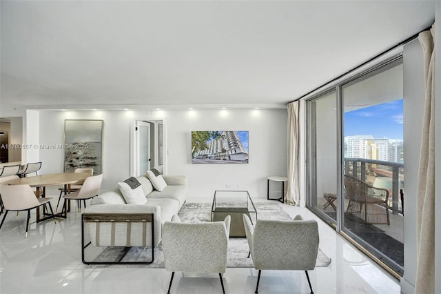 living room featuring marble finish floor and a wall of windows