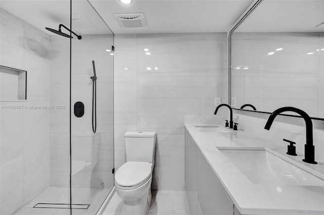 full bathroom featuring a sink, visible vents, toilet, and tile walls