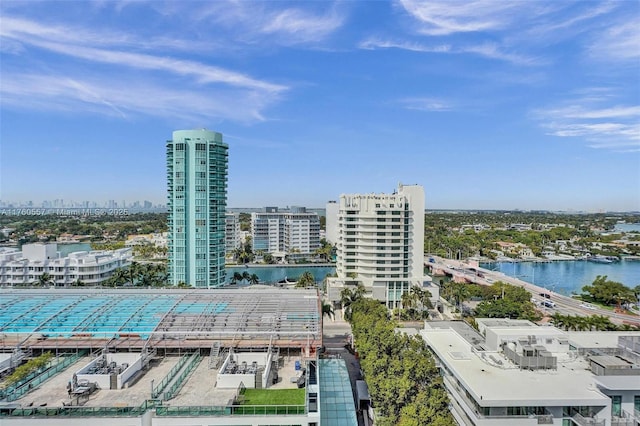 birds eye view of property featuring a city view and a water view