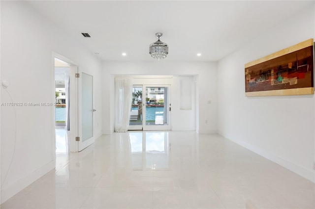 unfurnished room featuring recessed lighting, visible vents, and baseboards