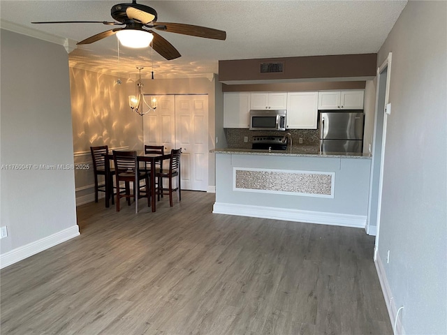 kitchen featuring white cabinets, wood finished floors, visible vents, and appliances with stainless steel finishes