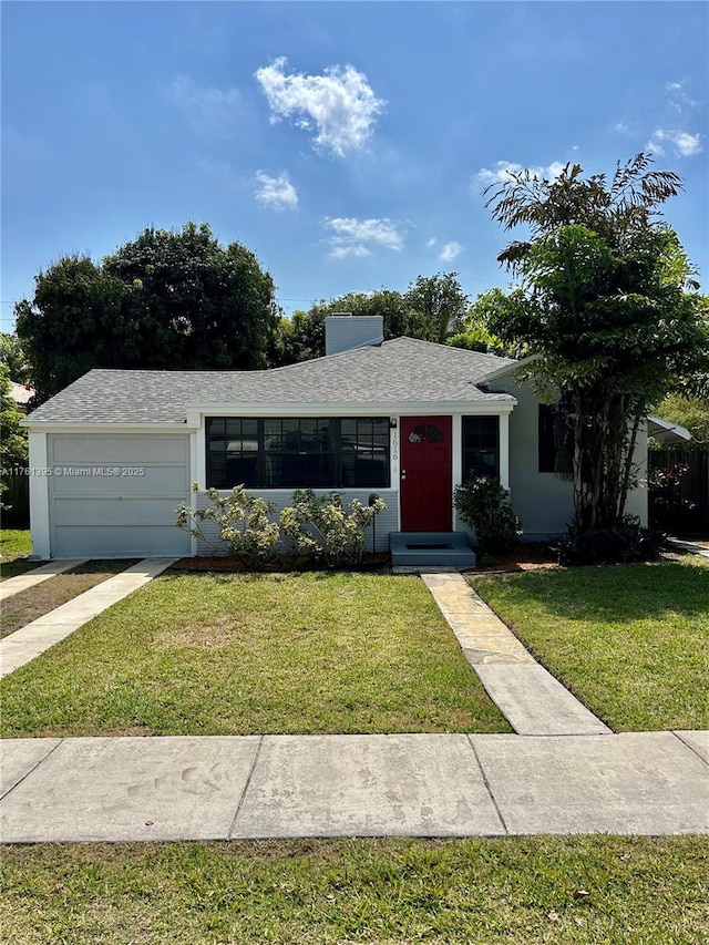 single story home featuring a garage, stucco siding, a front yard, and roof with shingles