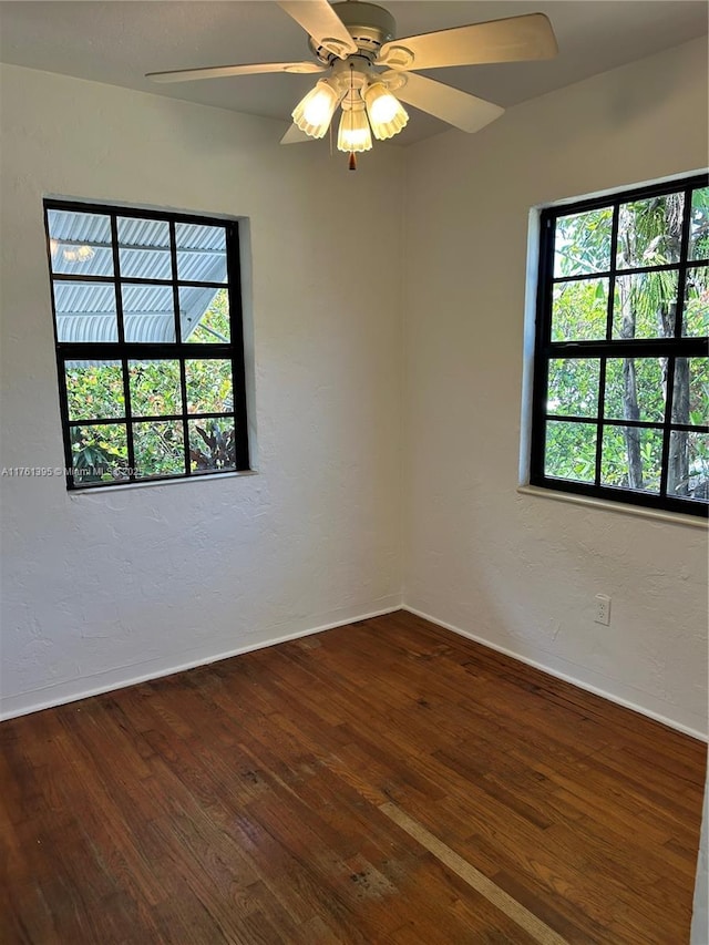 unfurnished room featuring a ceiling fan, a textured wall, and wood-type flooring