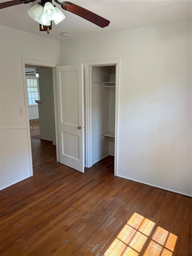 unfurnished bedroom featuring hardwood / wood-style floors, a ceiling fan, and a closet