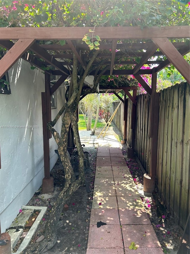 view of patio with a pergola and fence