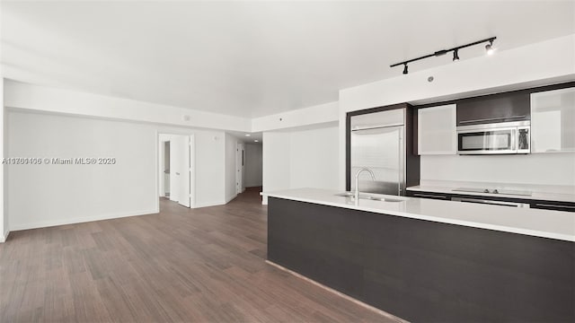 55 SE 6th St Unit 3701, Miami, FL 33131 - kitchen with dark wood-type flooring, baseboards, light countertops, appliances with stainless steel finishes, and a sink