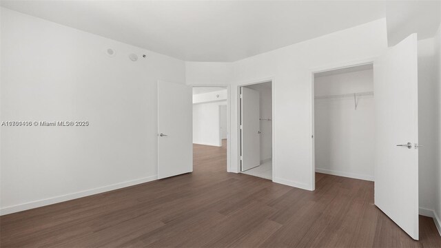 55 SE 6th St Unit 3701, Miami, FL 33131 - unfurnished bedroom featuring wood finished floors, a closet, and baseboards