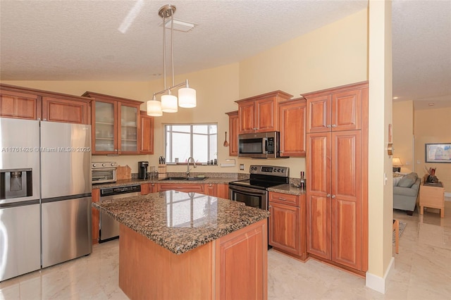 1154 SE 6th Ct, Dania Beach, FL 33004 - kitchen featuring vaulted ceiling, dark stone countertops, brown cabinetry, stainless steel appliances, and a sink