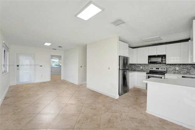 kitchen with backsplash, appliances with stainless steel finishes, white cabinetry, and light countertops