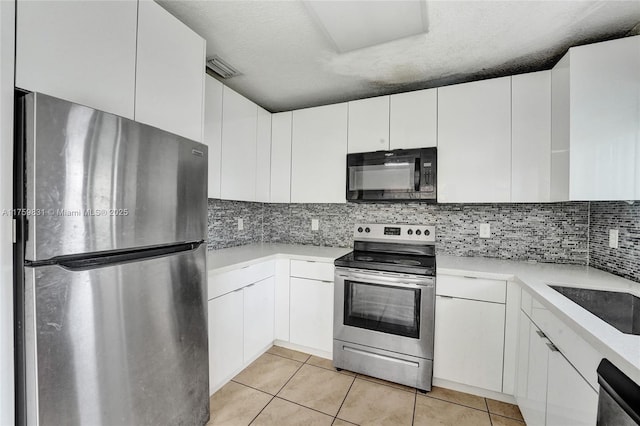 kitchen featuring light tile patterned floors, white cabinetry, appliances with stainless steel finishes, and light countertops