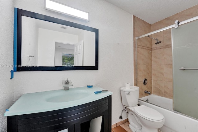 bathroom featuring toilet, a textured ceiling, shower / bath combination with glass door, vanity, and a textured wall