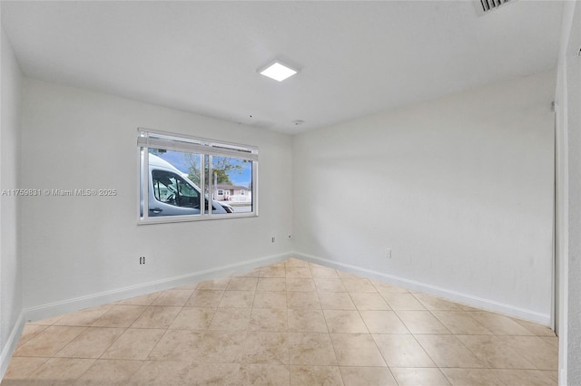 unfurnished room with tile patterned floors, visible vents, and baseboards