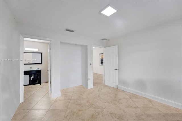 unfurnished bedroom with visible vents, baseboards, and light tile patterned flooring