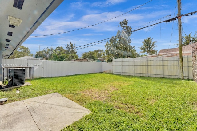 view of yard featuring cooling unit, a patio, and a fenced backyard