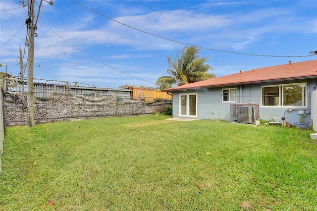 view of yard featuring cooling unit and fence