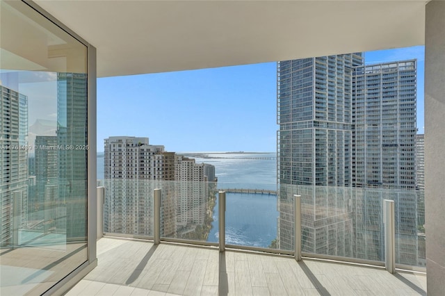 balcony with a water view and a city view