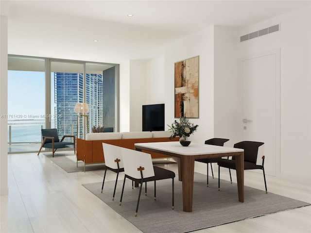 dining space with visible vents, recessed lighting, and expansive windows