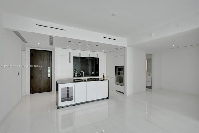 kitchen featuring visible vents, white cabinets, and modern cabinets