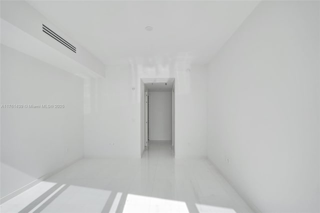 unfurnished room with light tile patterned floors and visible vents