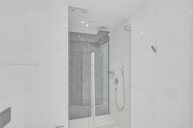 bathroom featuring a marble finish shower