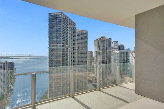 balcony with a view of city and a water view