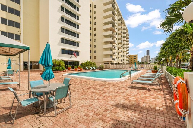 401 Golden Isles Dr Unit 516, Hallandale Beach, FL 33009 - community pool with a patio area