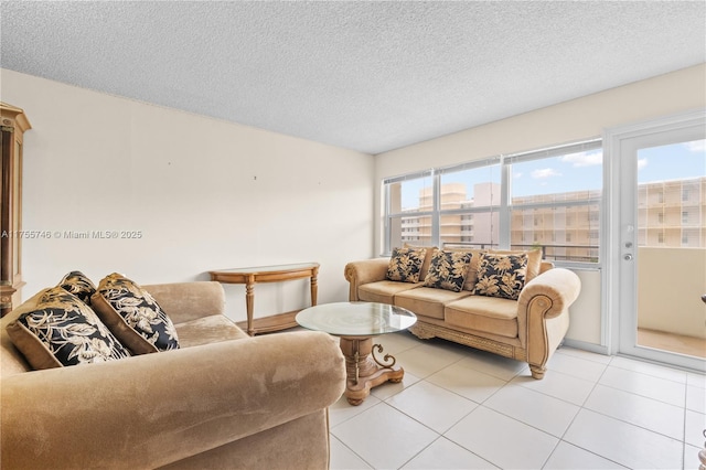 401 Golden Isles Dr Unit 516, Hallandale Beach, FL 33009 - living room with light tile patterned floors and a textured ceiling