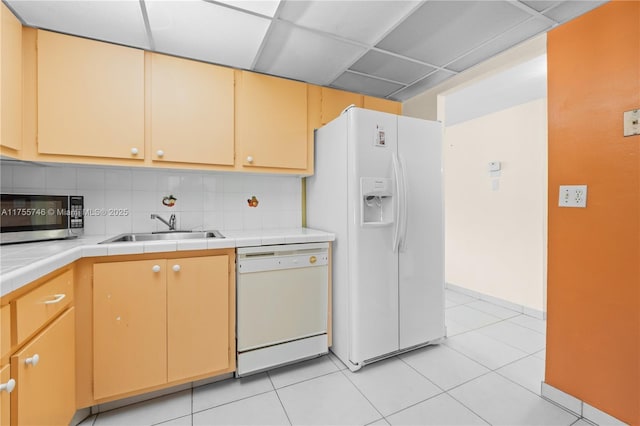401 Golden Isles Dr Unit 516, Hallandale Beach, FL 33009 - kitchen featuring white appliances, tile countertops, backsplash, light tile patterned floors, and a drop ceiling