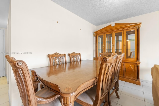 401 Golden Isles Dr Unit 516, Hallandale Beach, FL 33009 - dining space with light tile patterned flooring, a textured ceiling, and vaulted ceiling