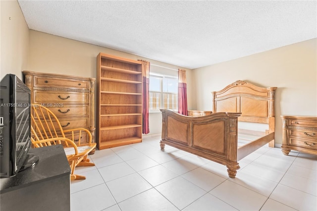 401 Golden Isles Dr Unit 516, Hallandale Beach, FL 33009 - bedroom featuring a textured ceiling and light tile patterned floors