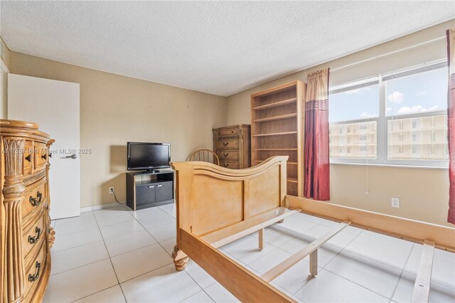 401 Golden Isles Dr Unit 516, Hallandale Beach, FL 33009 - bedroom with a textured ceiling and light tile patterned floors